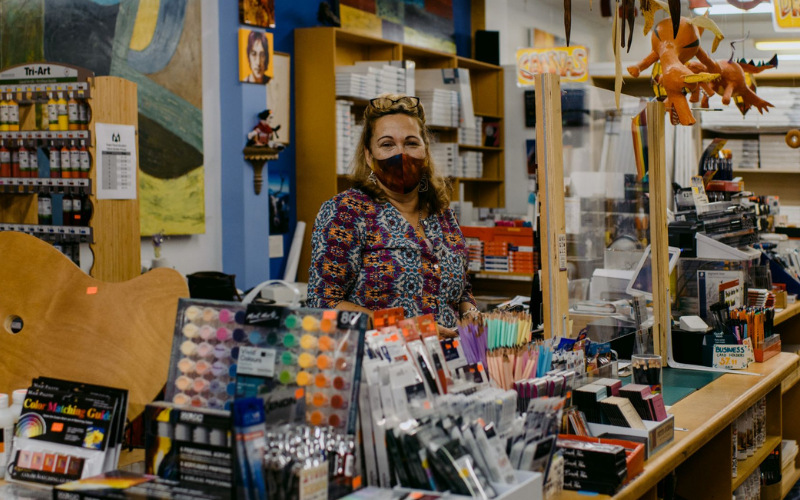 Shop owner standing in art shop